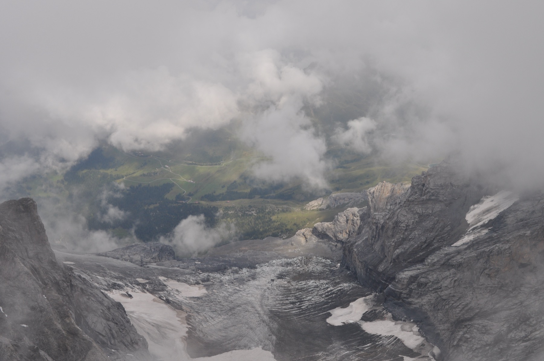 Clouds drifting over a rocky glacier valley in the Alps