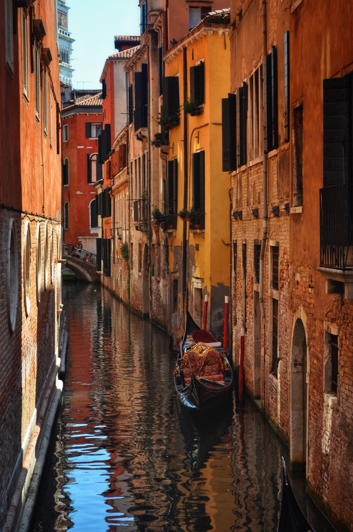 Gondolas moored in a narrow Venetian canal